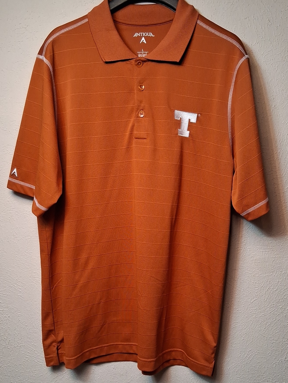 Antigua Men's Texas Longhorn Polo - Rust Orange with White 'T' Emblem